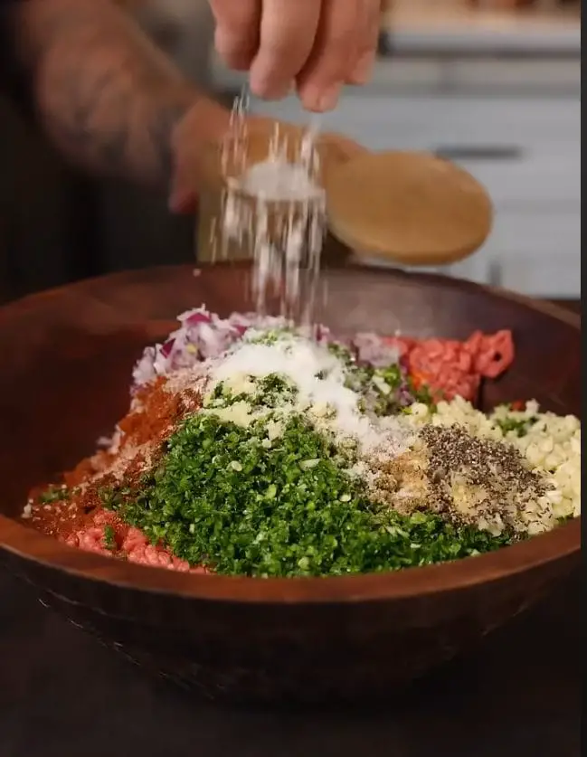 Spreading beef mixture onto tortilla for Viral Beef Tortilla Kebabs