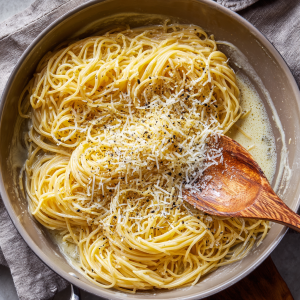 Freshly drained pasta tossed with melted butter and Parmesan in a skillet